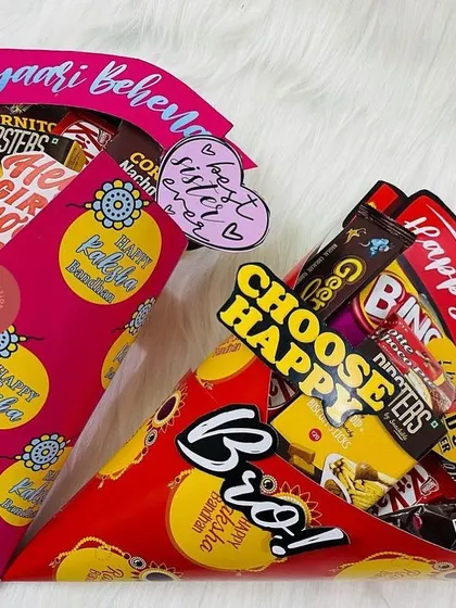 Our fun snack cone hampers for Raksha Bandhan. One is for the 'Pyaari Behen' (dear sister) and the other for the 'Bro', both filled with tasty treats.