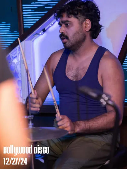 The drummer from The Kominas keeping the beat tight. The fusion of a live rock band with Bollywood disco tracks is a unique experience we love to create.