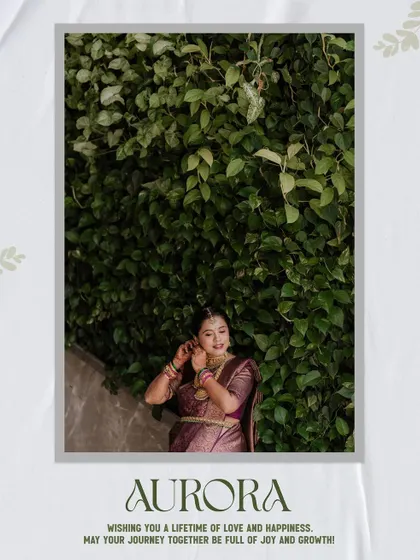 A candid shot from a traditional maternity session. The mother-to-be is seen against a wall of vibrant green leaves, her pose natural and elegant as she adjusts her traditional jewellery.