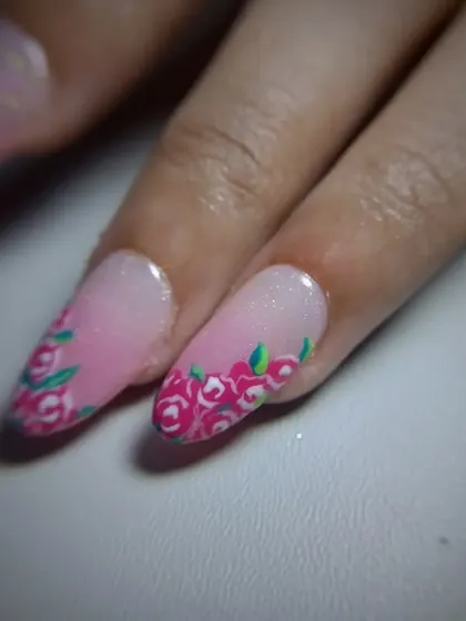 A full view of the pretty pink manicure with floral accent nails.