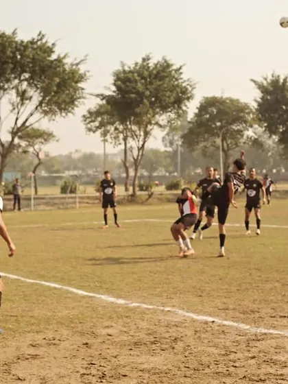 A player executes a powerful header during a competitive match in the Super League. This shows the aerial dominance we train for.