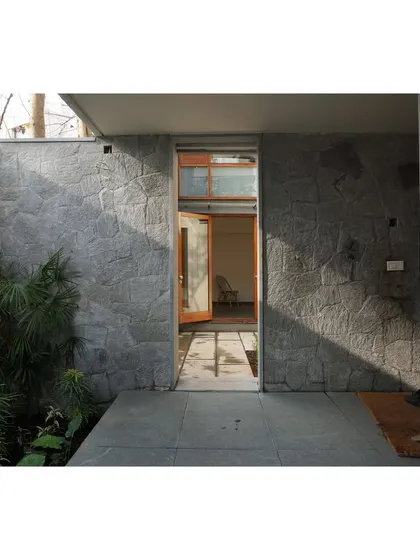 The sunlight highlights the rugged texture of the stone, bringing the material to life.