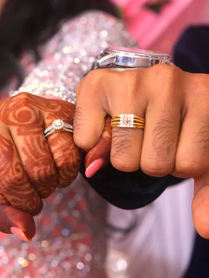 A fun "fist bump" pose showing off the couple's wedding rings.