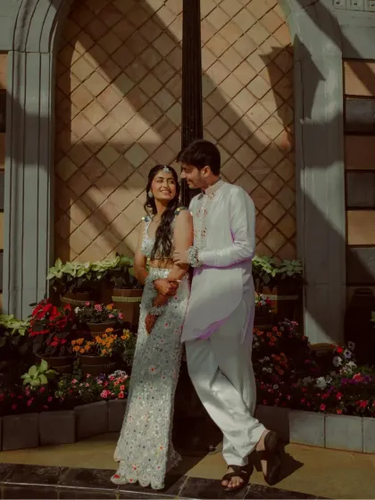 A stylish couple portrait against a European-style building, with the sunlight creating beautiful shadows.