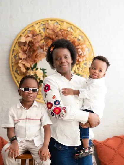 A fun and cool portrait. The older son dons sunglasses, adding a touch of personality to this memorable family photoshoot.
