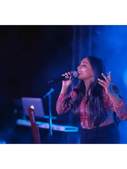 A candid of me singing, surrounded by green stage smoke.