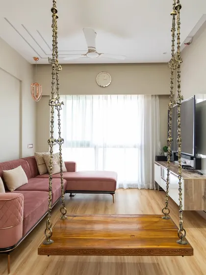 A cozy living room in another Mumbai home, featuring a traditional wooden swing.