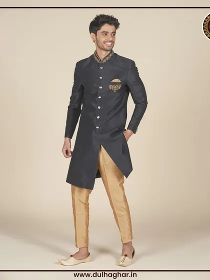 Another view of the black and gold Indo-Western outfit, highlighting its sharp, asymmetrical cut.
