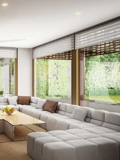 A home that lives and breathes with you. This living area opens up completely to the lush greenery outside, embodying our philosophy of designing in sync with nature. The large, comfortable sofa is perfect for family gatherings.