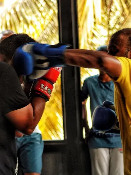 An experienced member lands a straight right during a controlled spar. His form shows years of practice and dedication to the craft.