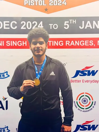 National Champion Daksh Choudhary proudly posing with his gold medal. His victory is a result of dedicated practice in the 25m pistol discipline.