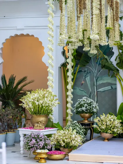 Another corner of the ceremony, showing the abundance of white flowers in brass pots and the elegant, traditional seating.