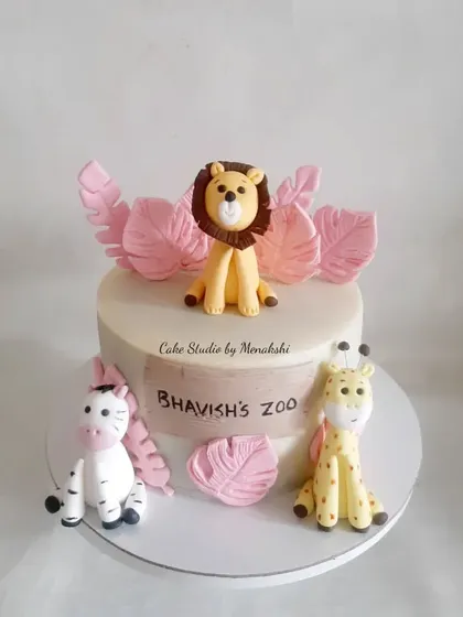 Bhavish celebrated his birthday with his own personal zoo. This cake features a lion, zebra, and giraffe, with pink leaves for a unique and soft color palette.