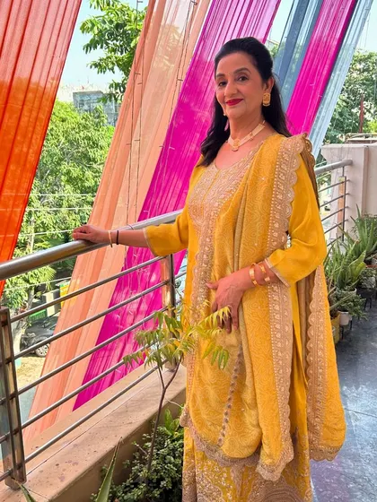 A full-length view of her in the yellow outfit. I can create multiple looks for different events during a wedding week.