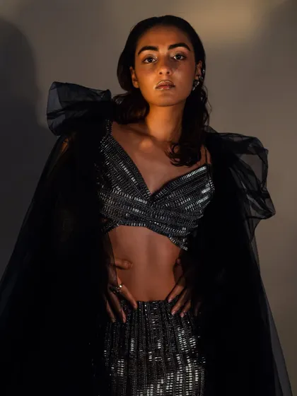 A portrait from the same series, showing the wet, slicked-back hair from the front, paired with a glowing, dewy makeup look.