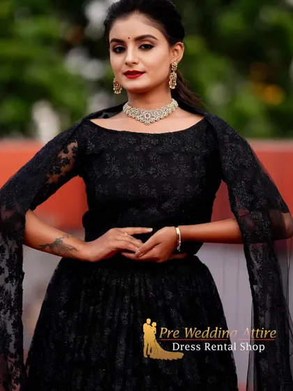 A close-up of the black lace lehenga, focusing on the delicate lace pattern of the off-shoulder blouse.