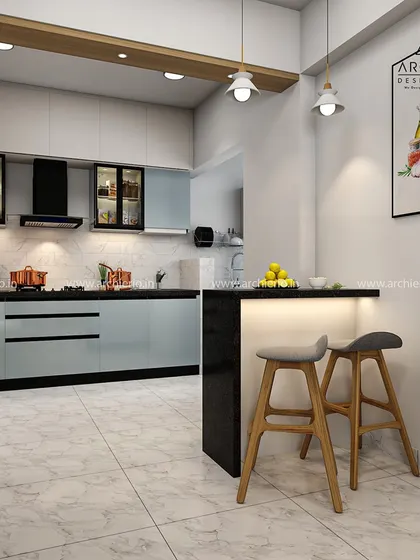 A wider view of the kitchen, showing the breakfast bar with stylish wooden stools. It's a perfect spot for morning coffee or a quick bite.