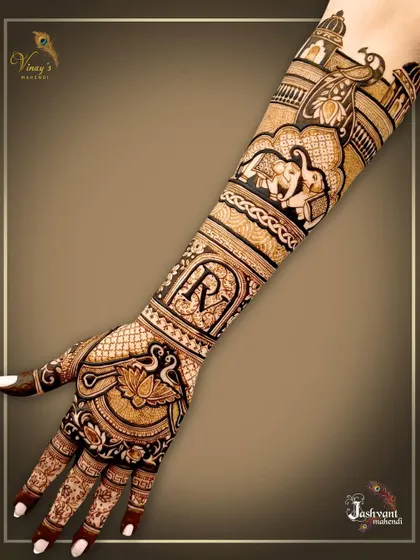 An elegant back-of-hand design personalized with the initial 'R'. The rest of the arm features classic wedding motifs like elephants and a bridal procession.