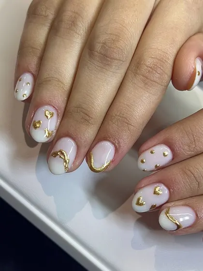 A cute and playful design with gold hearts and accents on a milky white base.