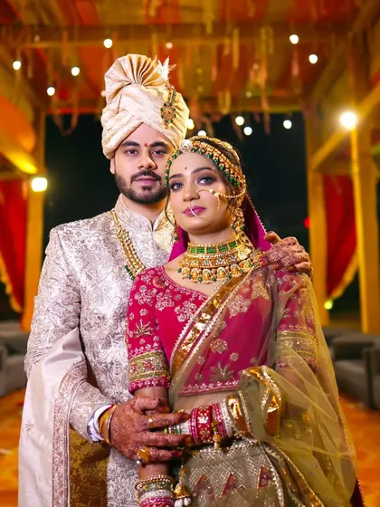 A classic, formal portrait of the wedding couple. Their regal attire and poised stance create a timeless image that is a must-have for any wedding album.
