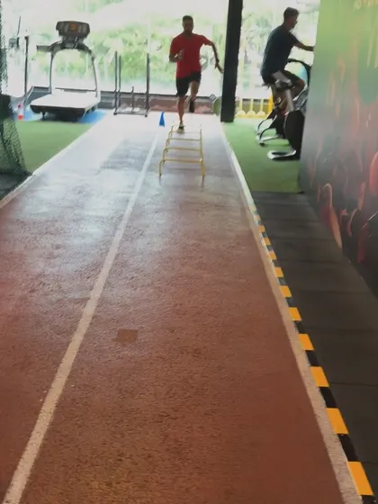 A client performs agility drills on our indoor track, a key part of our sports performance training.