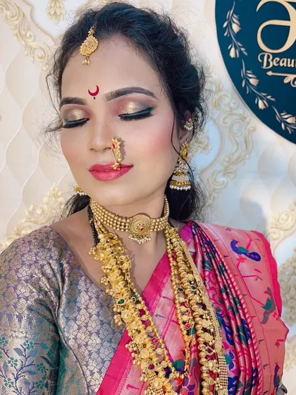 A close-up portrait showing the flawless base, shimmery eye makeup, and traditional jewellery in detail.