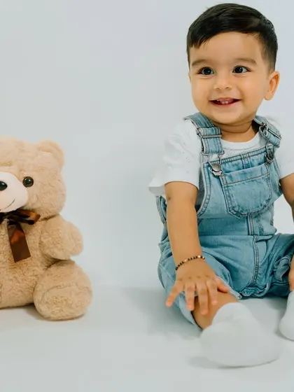 A boy and his best friend. This simple, classic portrait with a teddy bear is a timeless memory of childhood companionship.