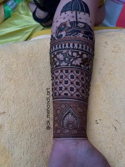 This image shows the elephant motif as part of a larger arm design, demonstrating how to integrate figurative work with abstract patterns.