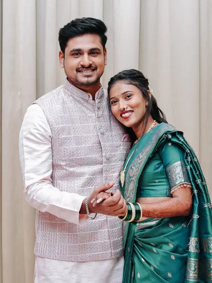 A happy portrait of a newly engaged couple holding hands and smiling.