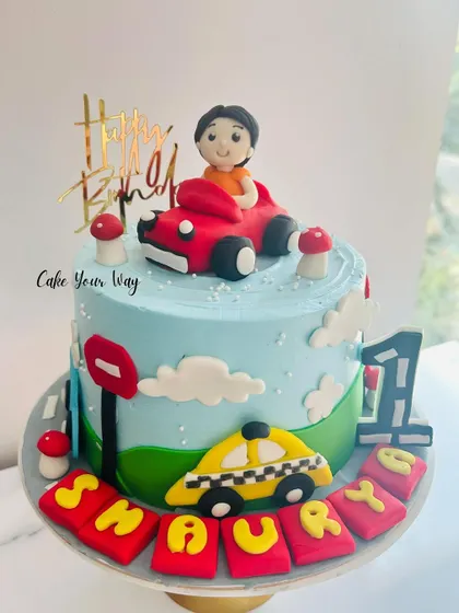 A year of joy and just the beginning. This car-themed first birthday cake is full of playful details.