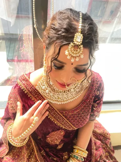 A detailed shot focusing on the eye makeup and jewelry. Learn to create stunning cut-crease eyeshadow looks with dramatic lashes, a popular request for modern brides.