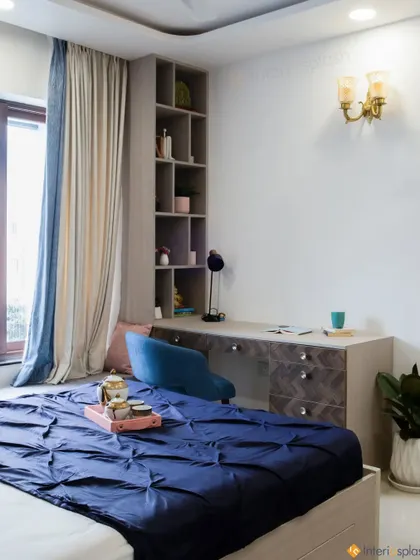 This shot shows the spacious study area integrated into the bedroom, with a large desk, comfortable chair, and plenty of shelving for books and decor.