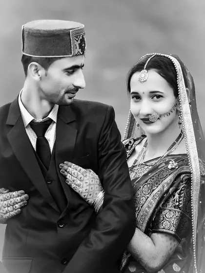 A classic black and white wedding portrait. The bride's hand on the groom's chest and their expressions create a timeless and intimate image.