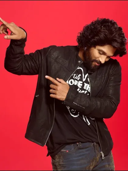 Allu Arjun against a vibrant red backdrop. This shot uses bold color and a dynamic pose to create a high-energy portrait that is both playful and confident, perfect for an engaging ad campaign.