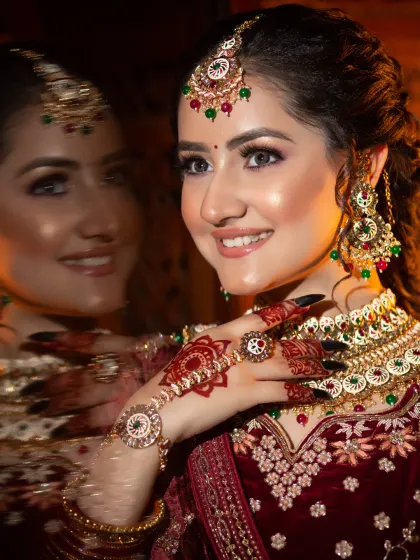 A creative shot with a reflection, showing the bride's happy expression. Capturing these joyful moments is one of the best parts of my job.