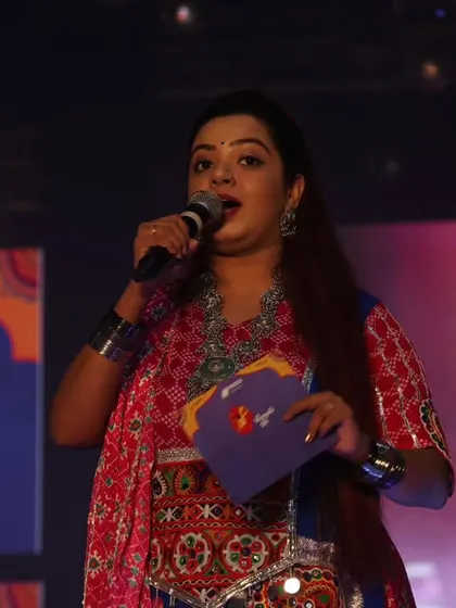 Engaging with the audience during the Saptami celebrations. Even in a large venue, I make it a point to create personal connections and make everyone feel part of the event.