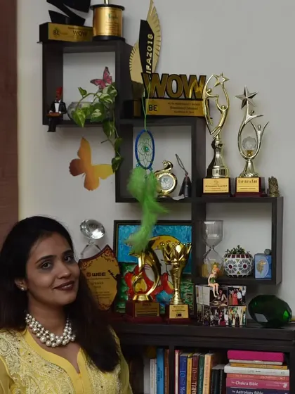 A portrait in my office, surrounded by my books and awards. This space is where the magic happens, a sanctuary for healing, guidance, and creation.