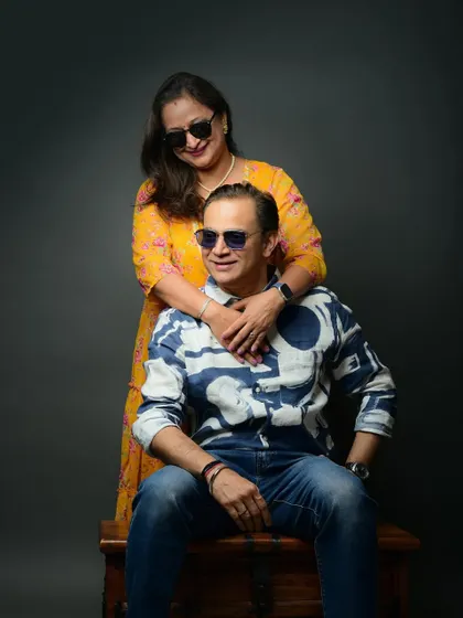 A fun and stylish shot from a 25th-anniversary session. Using props like sunglasses adds a playful and modern twist to the portraits.