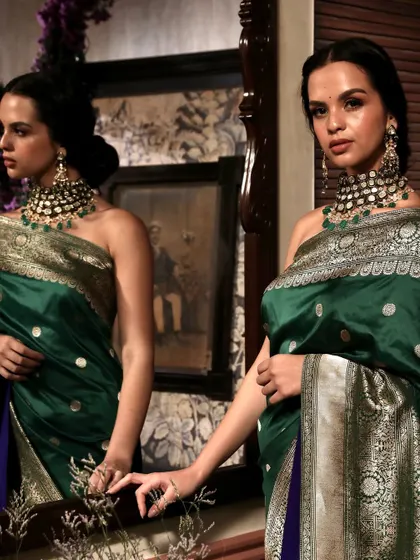 A creative mirror shot for Soho Begum, adding depth and intrigue to this portrait of a model in a green silk saree.