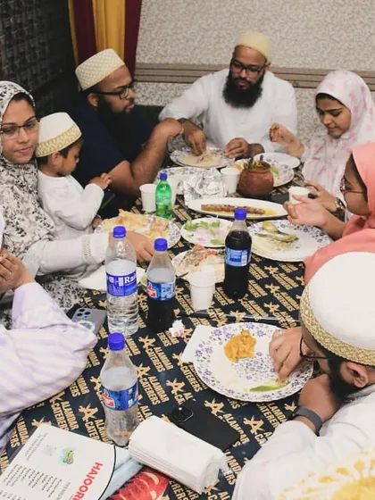 A family enjoying a traditional Bohra thaal style meal at our banquet. We cater to your specific customs and needs.