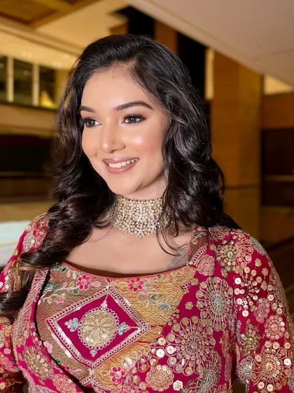 A close-up of the bride's happy expression. The makeup is radiant and camera-ready.