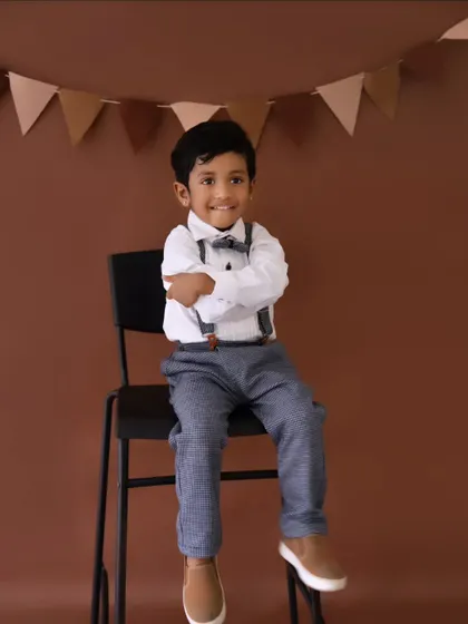 A dapper little gentleman in his bow tie and suspenders. I offer different outfit changes to provide a variety of looks during a birthday session.