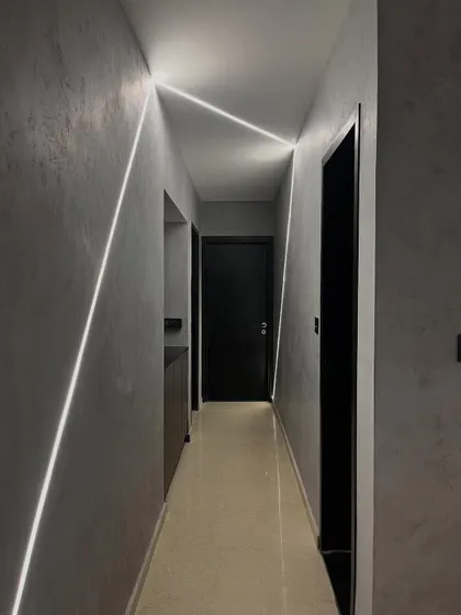 We turned this hallway into a runway with geometric lines of light. The integrated LED strips on the walls and ceiling create a futuristic and dynamic path, guiding you through the space.