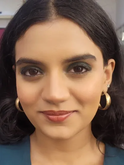 A sophisticated formal makeup look with a dark green smokey eye. This is a great alternative to a classic black smokey eye and pairs beautifully with warm skin tones.