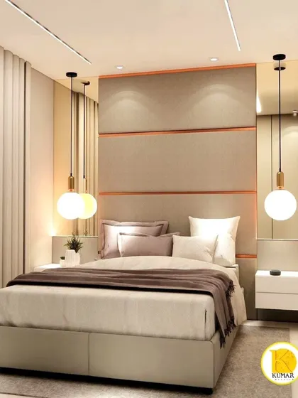 A bedroom with a large, upholstered headboard with copper inlay details.