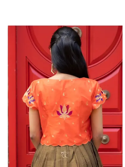 The back of the jacket is adorned with beautiful lotus embroidery, adding a unique and artistic detail.