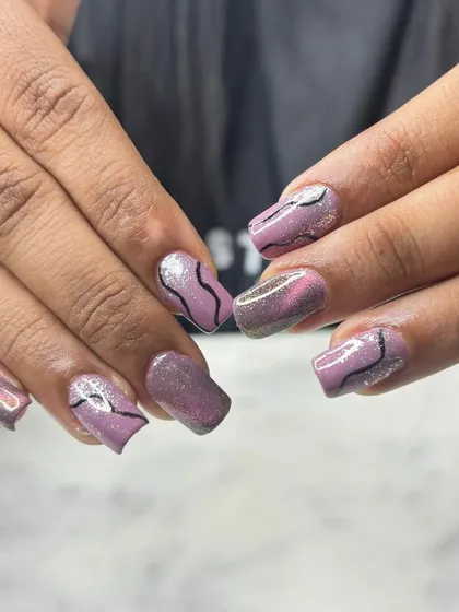 Another angle of the purple and black abstract nail art. This shows that you can have intricate and fun designs on any nail length.