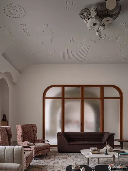 This shot captures the beautiful details of the formal living room, from the custom gypsum patterns on the vaulted ceiling to the elegant furniture arrangement. It’s a space designed for conversation and appreciation of art.