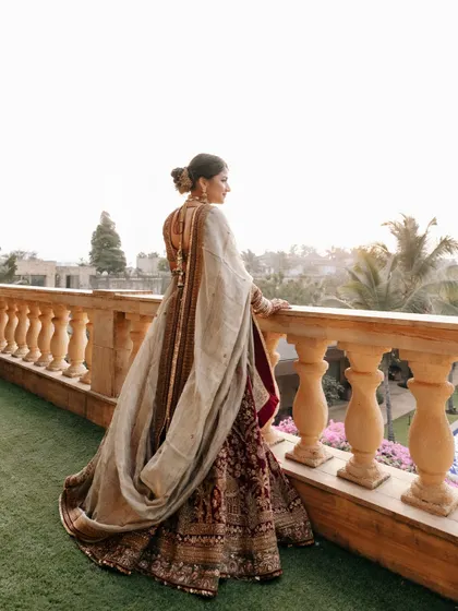 The bride, Prachi, looking out from a balcony at Della Resorts. This pensive, over-the-shoulder shot is both beautiful and full of emotion.