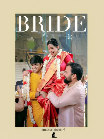 A joyful moment from a South Indian wedding, where the bride is lifted up by her family during a traditional ritual.